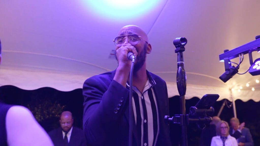Man singing at event in live entertainment band