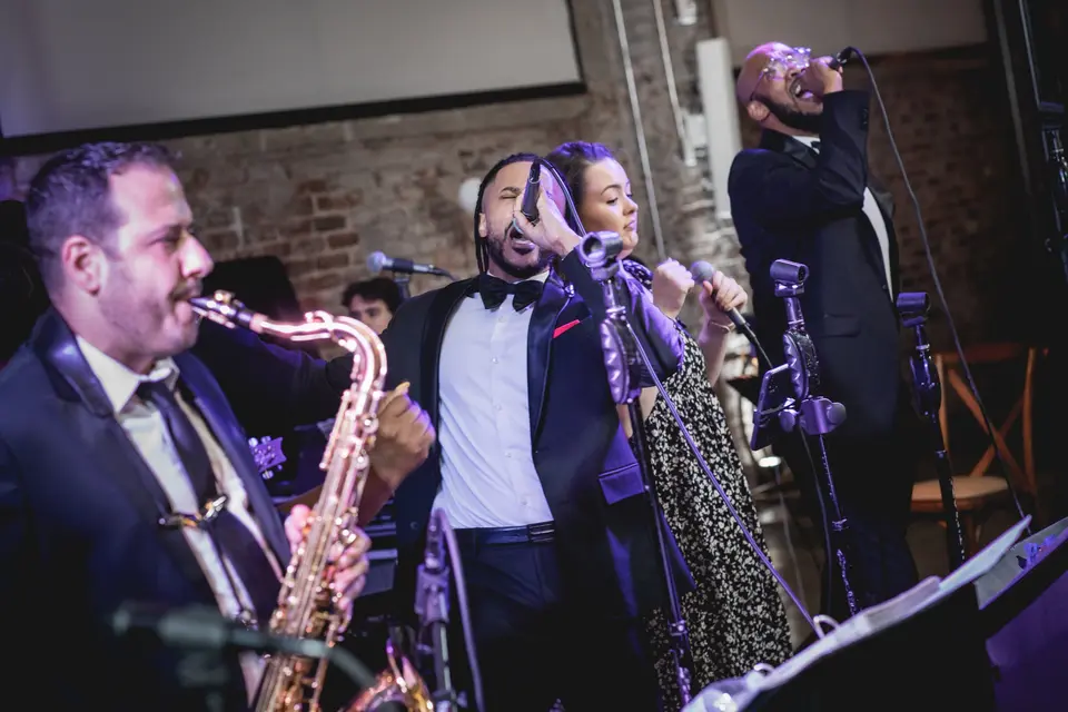 Members of the Jack Faulkner Orchestra band singing and performing
